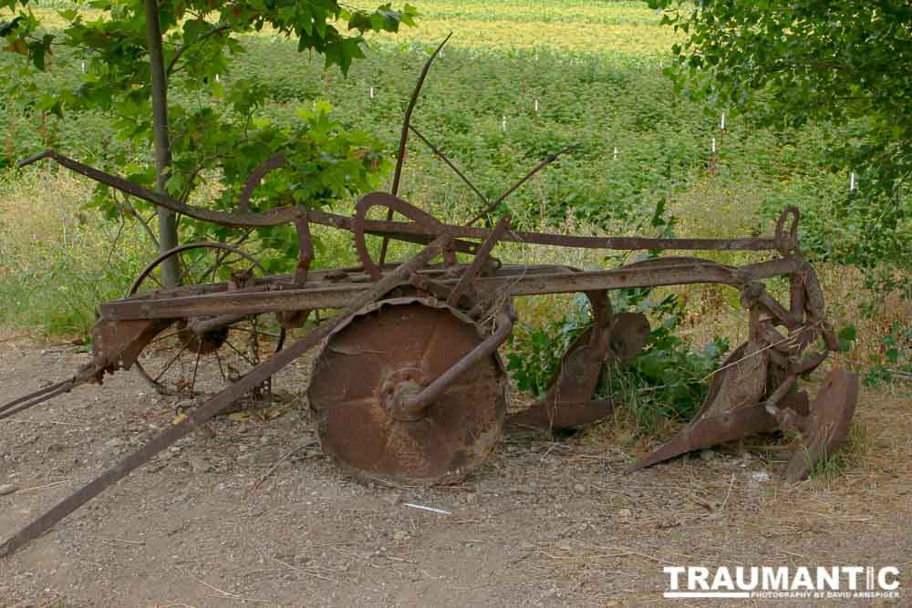 A rusting old farm vehicle.