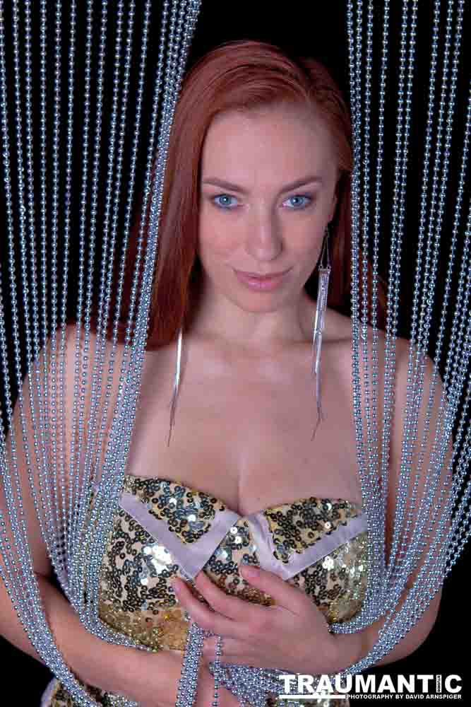 Playboy Cover Model Titania Lyn and a beaded curtain