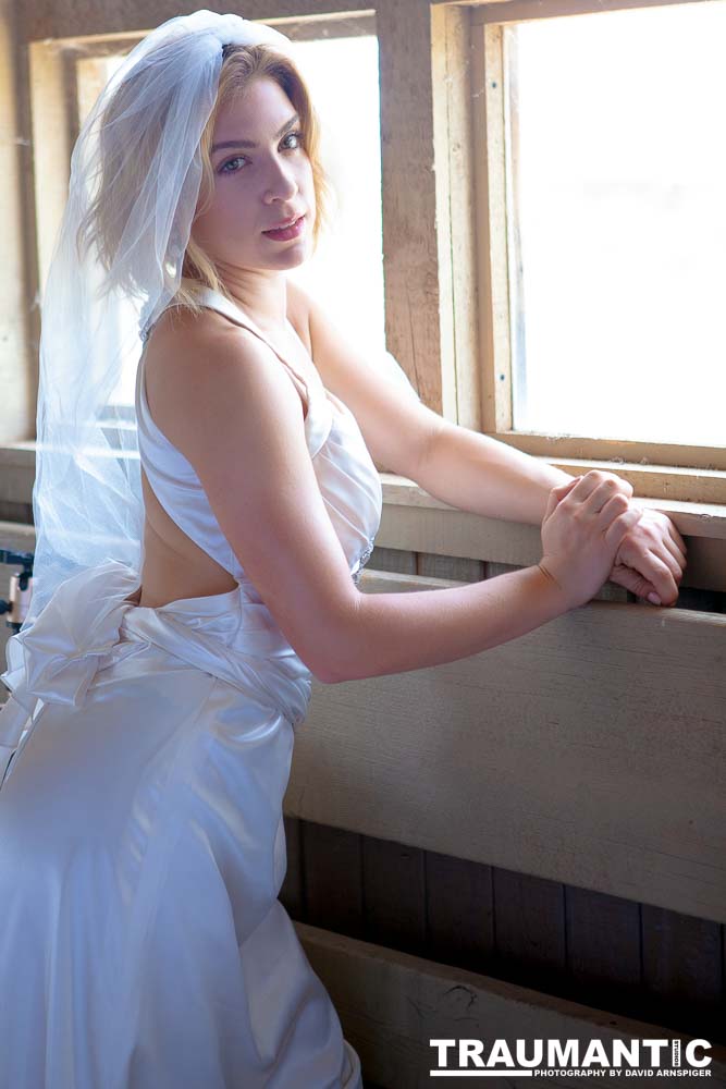 Cowgirl brides in the mid-day sun at an old church.