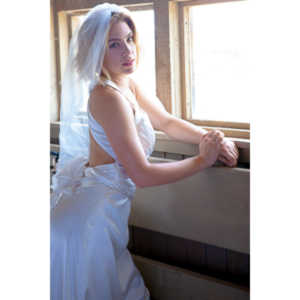 Cowgirl brides in the mid-day sun at an old church.