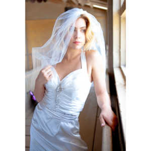 Cowgirl brides in the mid-day sun at an old church.