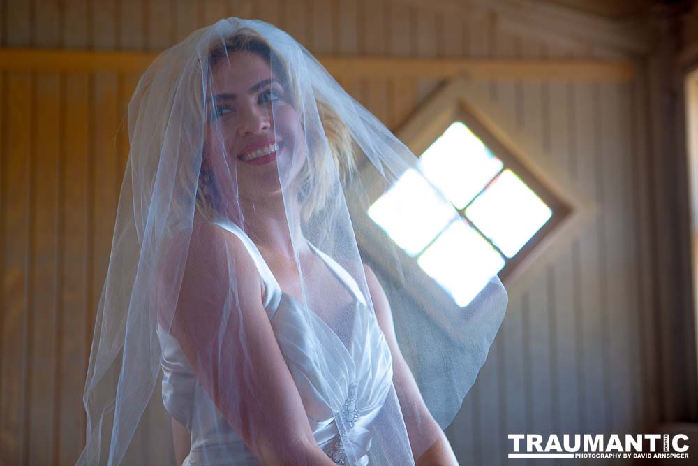 Cowgirl brides in the mid-day sun at an old church.