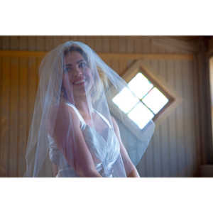 Cowgirl brides in the mid-day sun at an old church.