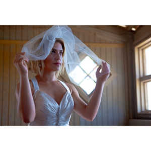 Cowgirl brides in the mid-day sun at an old church.