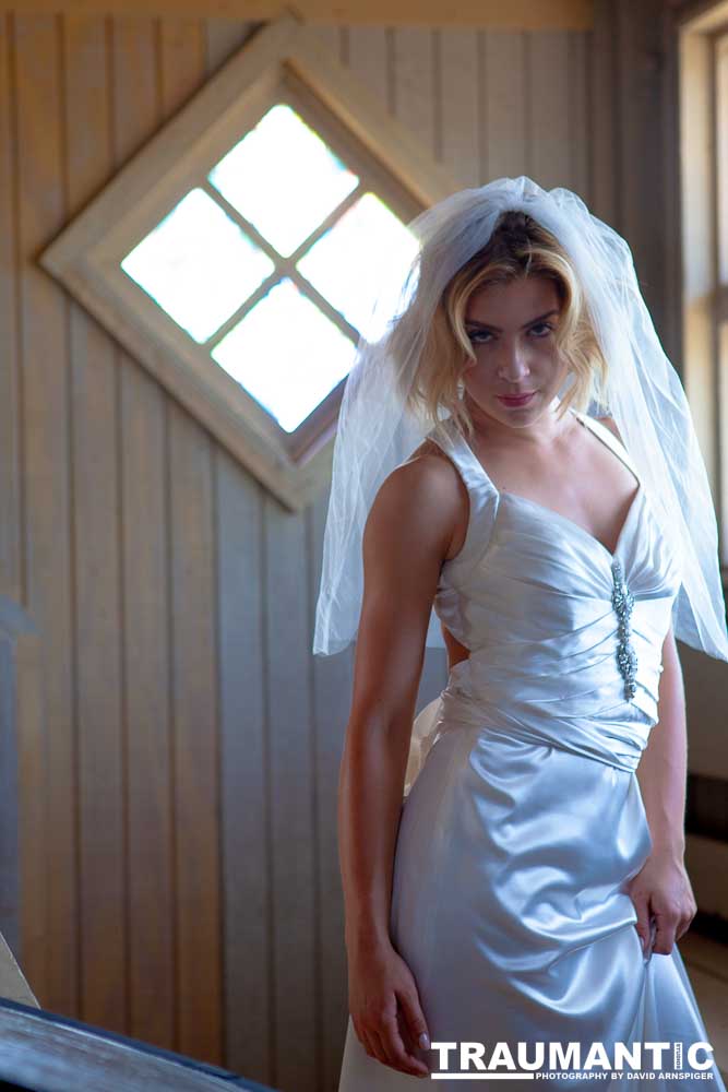 Cowgirl brides in the mid-day sun at an old church.