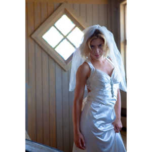 Cowgirl brides in the mid-day sun at an old church.