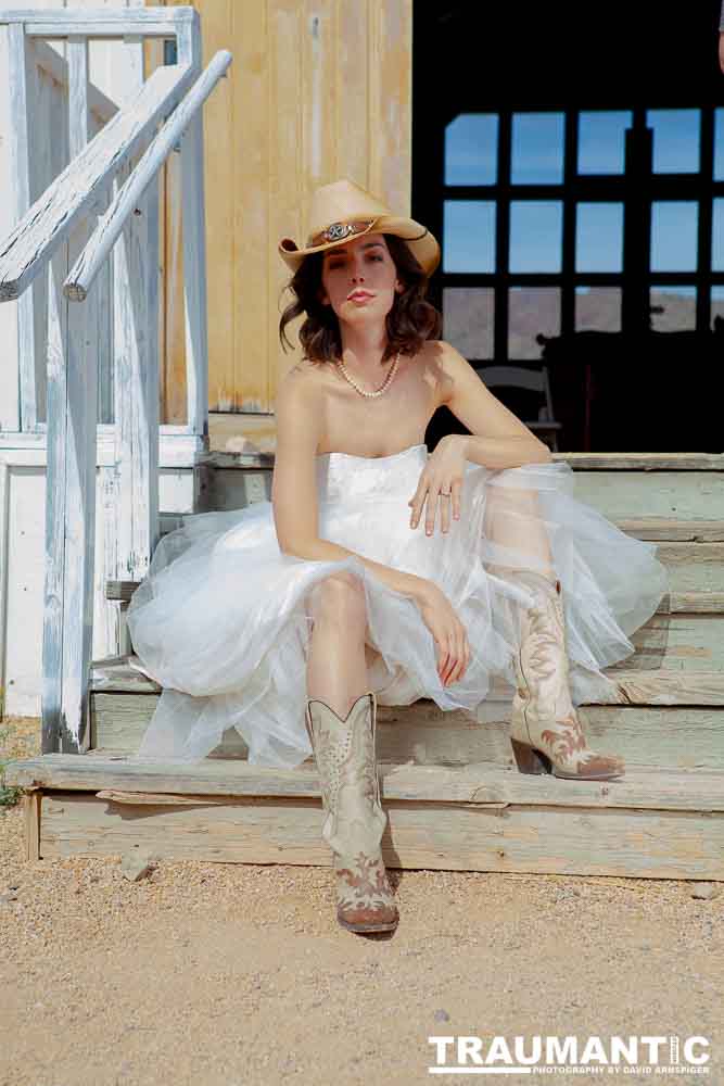 Cowgirl brides in the mid-day sun at an old church.