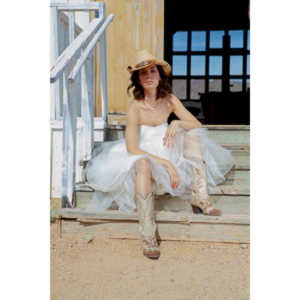 Cowgirl brides in the mid-day sun at an old church.