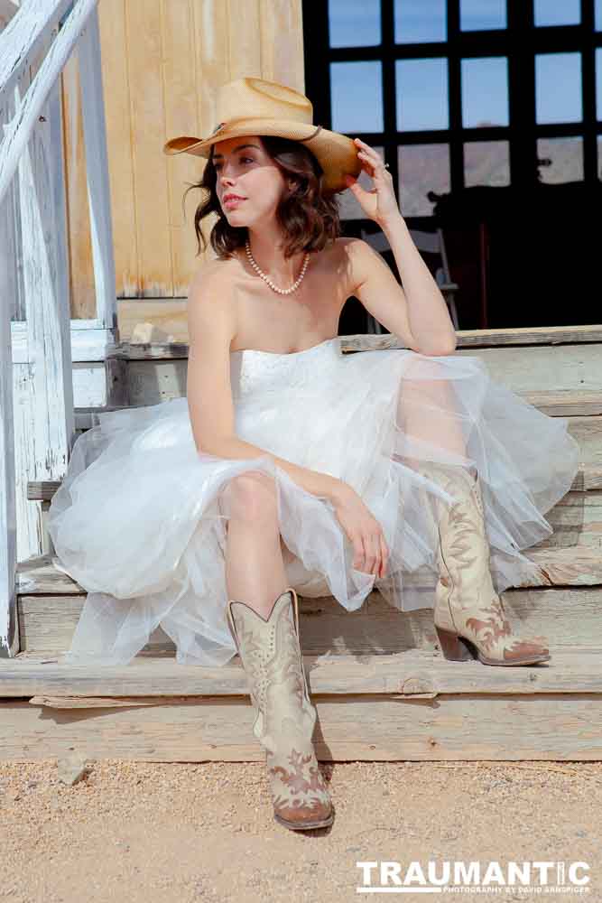 Cowgirl brides in the mid-day sun at an old church.