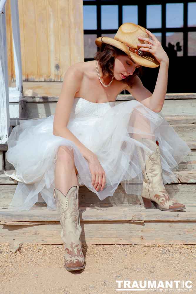 Cowgirl brides in the mid-day sun at an old church.