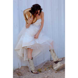 Cowgirl brides in the mid-day sun at an old church.