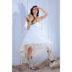 Cowgirl brides in the mid-day sun at an old church.