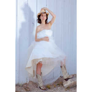 Cowgirl brides in the mid-day sun at an old church.