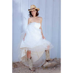 Cowgirl brides in the mid-day sun at an old church.