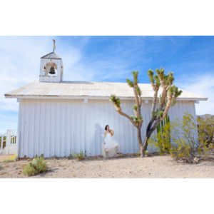 Cowgirl brides in the mid-day sun at an old church.