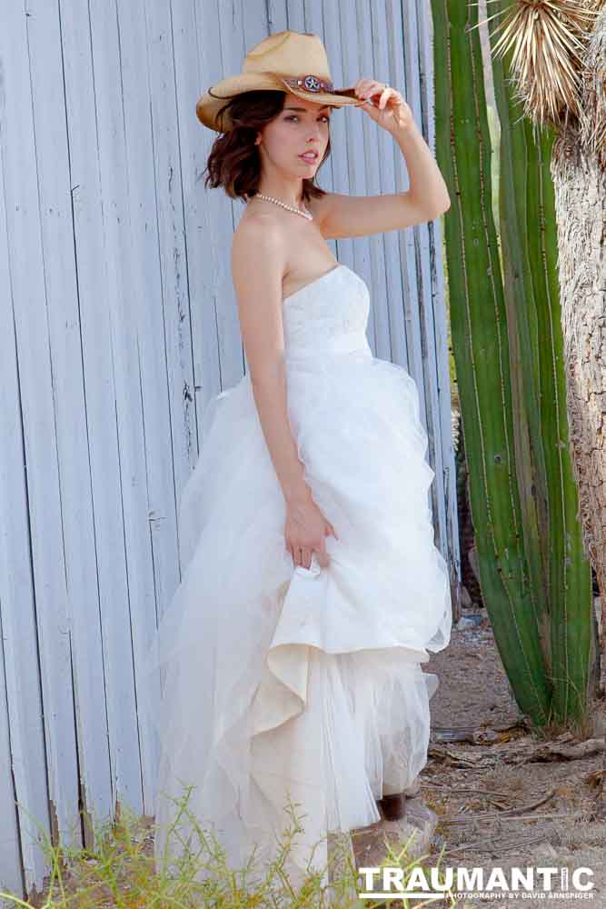 Cowgirl brides in the mid-day sun at an old church.