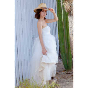 Cowgirl brides in the mid-day sun at an old church.