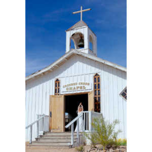 Cowgirl brides in the mid-day sun at an old church.