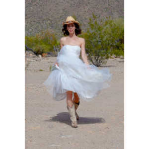 Cowgirl brides in the mid-day sun at an old church.