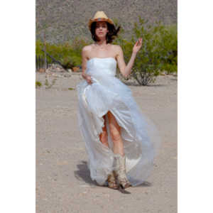 Cowgirl brides in the mid-day sun at an old church.