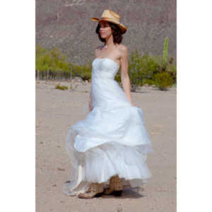 Cowgirl brides in the mid-day sun at an old church.